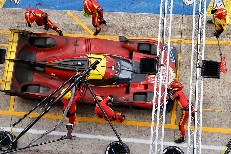 Mechanics refuel the Ferrari AF Corse team car